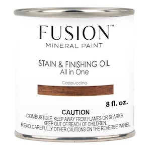 May include: A white can of Fusion Mineral Paint Stain & Finishing Oil in the color Cappuccino. The can is labeled with the product name, color, and size: 8 fl. oz.  Caution: Combustible. Keep away from flames or sparks. Keep out of reach of children. Read carefully other cautions on the reverse panel.