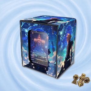 May include: A square deck box featuring a blue and black graphic print of a spiky-haired character and a chandelier, with a clear window displaying a trading card inside. Beside the box are several small, metallic gold multi-sided dice.