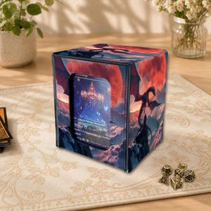 May include: A square deck box featuring a vibrant fantasy illustration of a black dragon flying over a mountainous landscape under a large red moon. The front panel has a clear window displaying a trading card with text including Island Swamp Mountain.