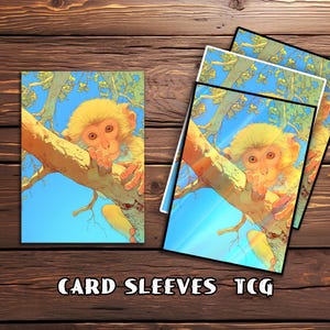 May include: Card sleeves featuring a whimsical illustration of a monkey perched on a tree branch against a blue sky. The monkey has yellow fur and is holding its chin. The text "CARD SLEEVES TCG" is at the bottom.