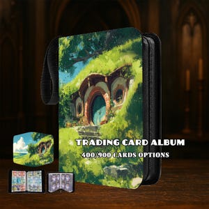 May include: A trading card album with a fantasy illustration of a hobbit hole. The album has a black zipper and a black handle. Text on the album reads "TRADING CARD ALBUM 400/900 CARDS OPTIONS".