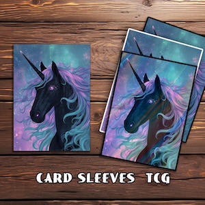 May include: Card sleeves featuring a fantasy unicorn illustration. The artwork depicts a black unicorn with a long, spiraled horn, flowing purple and teal mane, and glowing purple eyes. The background is a nebula of purples, blues, and greens. The text "CARD SLEEVES TCG" is at the bottom.