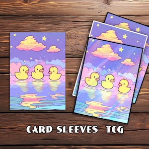 May include: Card sleeves featuring an illustrated design of yellow rubber duckies swimming in a body of water under a pastel sky with clouds and stars. The text "CARD SLEEVES TCG" is printed at the bottom.