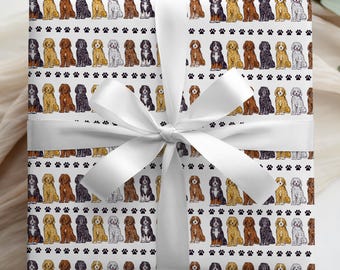 May include: Gift wrap featuring a repeating pattern of various dog breeds in shades of brown, black, and cream, with black paw prints. The gift is tied with a white satin ribbon and bow.