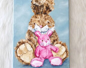 May include: A painting of a brown plush bunny holding a pink plush bunny. The bunnies are sitting on a light blue background.