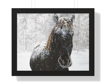 May include: Framed print of a horse in a snowy forest. The horse is dark brown with a light brown mane, covered in snow. The background shows a snowy forest with white trees and a soft, blurred effect.