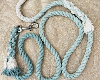 May include: A blue and white cotton rope dog leash with a silver clip.