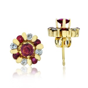 May include: A pair of gold earrings with a flower design. The earrings are set with red rubies and white diamonds.
