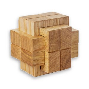 May include: A wooden puzzle with a complex interlocking design. The puzzle is made of multiple pieces of wood that fit together to form a cube shape.