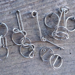 Hanayama Wire Puzzle Set - Orange contains 5 mini wire puzzles. IQ Logic, Brain Teaser, Puzzle Master. image 1