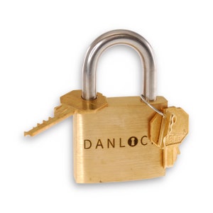 May include: A brass padlock with a silver shackle and two keys. The padlock has the word "DANLOCK" engraved on the front.