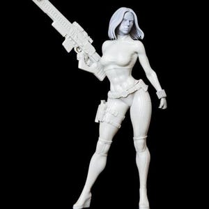 May include: A white figurine of a woman holding a large rifle, set against a black background. The figure is wearing a crop top, fitted pants, and a utility belt with a holster. The woman has short hair and a determined expression.