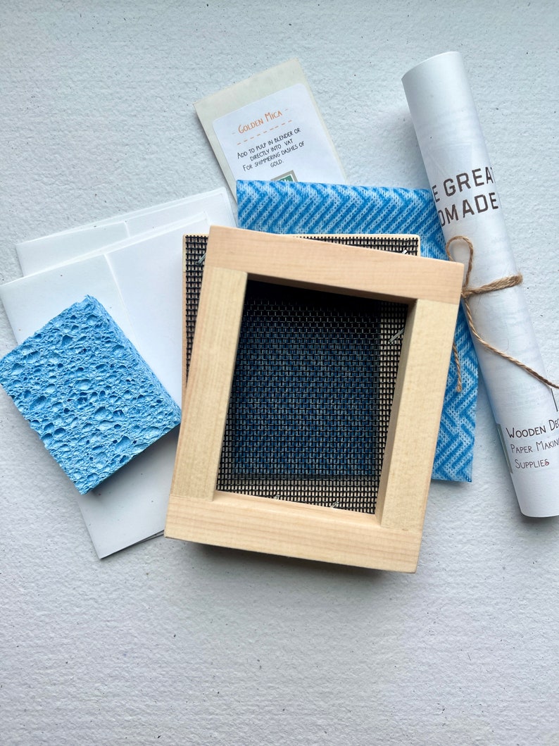 The 3x4" mould and deckle, sponge, envelopes and card stock, instruction book, and gold mica.