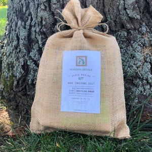 The eco friendly burlap bag containing this WoodenDeckle papermaking kit.