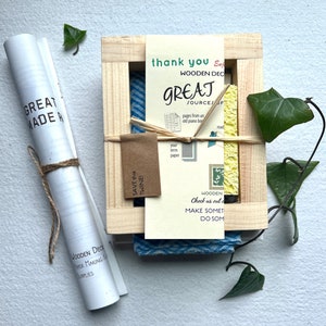 The instruction booklet, notecard mould and deckle, and other contents of this papermaking kit.