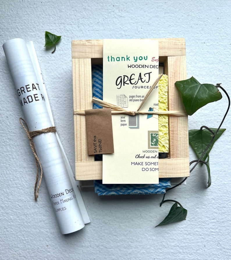 The instruction booklet, notecard mould and deckle, and other contents of this papermaking kit.
