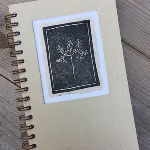 3x4" homemade paper with a fern stamp, applied to the cover of a journal.