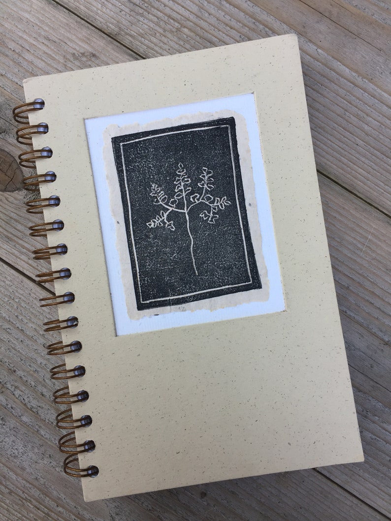 3x4" homemade paper with a fern stamp, applied to the cover of a journal.