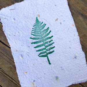 Handmade stationary stamped with a green fern.