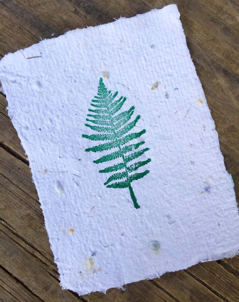 Handmade stationary stamped with a green fern.