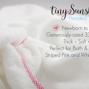 May include: White hooded towel with a pink and white striped trim. The towel is generously sized at 33 x 33 inches and is designed for newborns to age 3. The text "tiny Sunshine Hooded Towels" is visible.