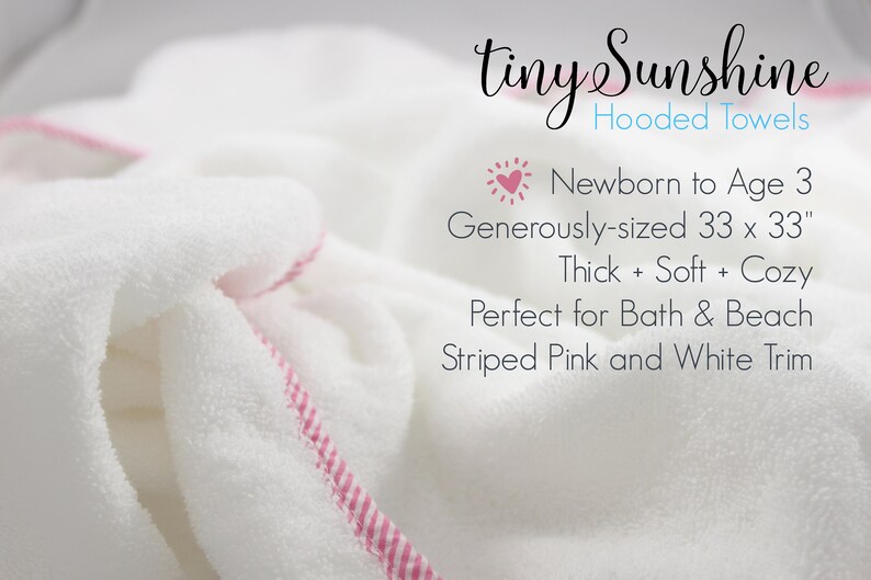 May include: White hooded towel with a pink and white striped trim. The towel is generously sized at 33 x 33 inches and is designed for newborns to age 3. The text "tiny Sunshine Hooded Towels" is visible.