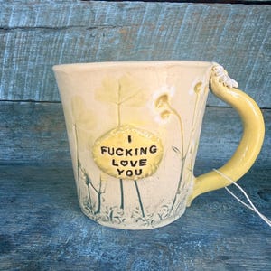 May include: A set of three ceramic mugs with a speckled, matte finish. The mugs are in shades of cream, light gray, and dark gray. Each mug has a simple, minimalist design, perfect for coffee or tea.