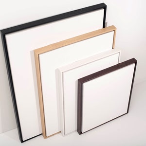 May include: Four different sized picture frames with white mats and various wood finishes. The frames are black, natural wood, white, and dark brown.