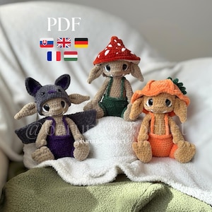 May include: Three crocheted dolls with large eyes and pointed ears. One wears a red and white mushroom hat and green overalls, one a purple bat hood and purple overalls, and one an orange carrot hat with orange overalls. Text reads PDF.