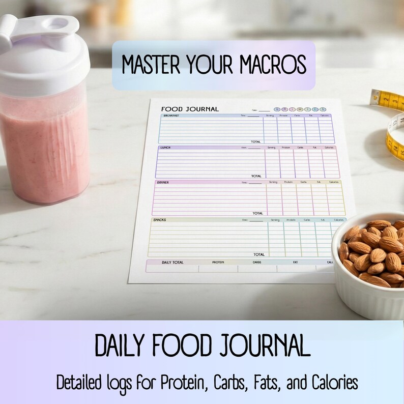 May include: A pink smoothie in a white and clear shaker bottle, a food journal, a bowl of almonds, and a measuring tape are on a white surface. The journal has the text "FOOD JOURNAL" and "MASTER YOUR MACROS". The text "DAILY FOOD JOURNAL" and "Detailed logs for Protein, Carbs, Fats, and Calories" are also visible.