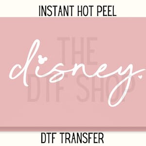 May include: A pink rectangular graphic with the word "Disney" in white script, featuring a Mickey Mouse head as the dot of the "i". The text "INSTANT HOT PEEL" and "DTF TRANSFER" are above and below the main text.
