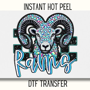 May include: A blue and white ram with iridescent rhinestones, the word "Rams" in blue and white, and the text "INSTANT HOT PEEL DTF TRANSFER" in black.