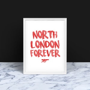May include: White framed print with red text that reads "North London Forever" and a red cannon logo.