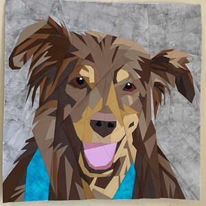May include: A brown and tan dog with a pink tongue sticking out, wearing a turquoise blue bandana. The dog is made of fabric and is a patchwork of different shapes.