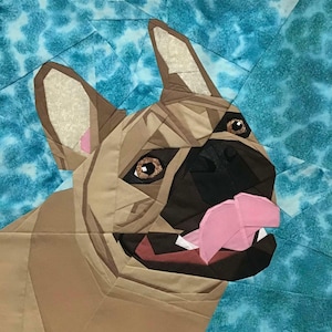 May include: A close-up of a French bulldog with brown fur, black nose, and pink tongue sticking out. The dog is looking to the right of the image. The background is a blue and white tie-dye pattern.