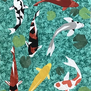 May include: A colourful quilt featuring a pattern of koi fish swimming in a turquoise pond with green lily pads. The koi fish are red, white, black, and yellow.