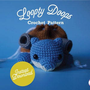 May include: Crochet pattern for a blue and brown loopy dopp, a crocheted pouch with a drawstring. The pattern is available for instant download. The image shows the finished crocheted pouch.