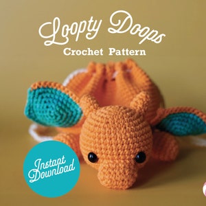 May include: A crocheted orange and teal stuffed animal shaped like a dragon with large ears. The dragon is lying on its belly with its head facing the camera. The text "Loopy Doops Crochet Pattern" is above the dragon. The text "Instant Download" is in a circle with a teal background.