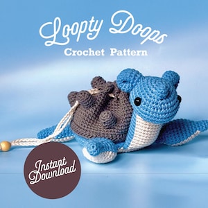 Puede incluir: Un juguete de amigurumi de tortuga azul y gris tejido a crochet con el texto "Loopy Doops Crochet Pattern" y "Instant Download" sobre un fondo azul claro.