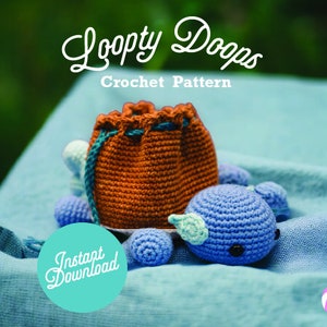 May include: An image of a crochet pattern with the text "Loopy Doops Crochet Pattern". The image features a small, orange drawstring bag, a blue whale, and several blue and white crochet balls. A teal circle with the words "Instant Download" is also present.