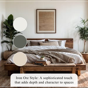 May include: A bedroom with a wooden bed, beige bedding, and a wooden bench at the foot of the bed.  There are two plants, one on each side of the bed.  A large framed picture hangs on the wall above the bed.  Three paint swatches are shown: off-white, dark green, and beige. The text 'Iron Ore Style: A sophisticated touch that adds depth and character to spaces' is visible at the bottom.