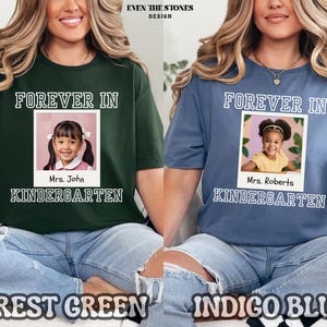 May include: Forest green and indigo blue t-shirts with the text "FOREVER IN KINDERGARTEN" and a photo of a young girl. The forest green shirt has the name "Mrs. John" and the indigo blue shirt has the name "Mrs. Roberts" below the photo.