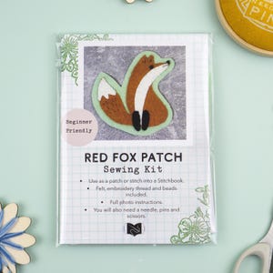 May include: A Red Fox Patch sewing kit in clear packaging. The label features a felt fox illustration, the text "Beginner Friendly," "RED FOX PATCH Sewing Kit," and a list of included materials like felt, embroidery thread, and beads.