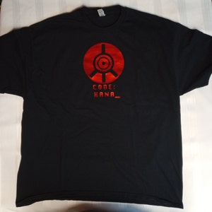 May include: Black t-shirt with a red graphic of a circle with a target inside and the text "CODE: HANA_" underneath.