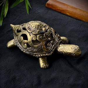 Handmade bronze turtle figurine for spiritual balance and interior harmony with a symbolic design and openwork shell for home or office deco