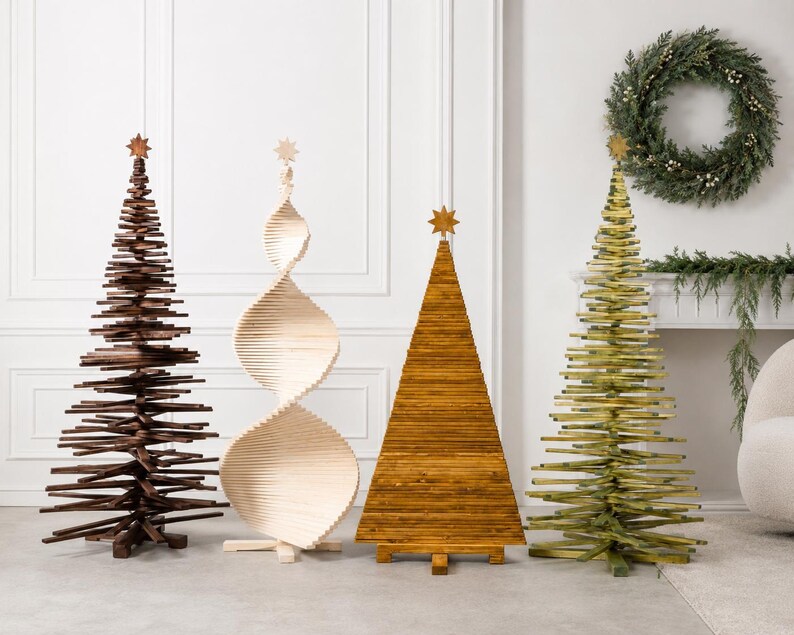 May include: Four decorative wooden Christmas trees standing in a row. The first is dark brown, the second is a light natural wood spiral, the third is a solid golden-brown triangular shape, and the fourth is a green tree, all topped with stars.