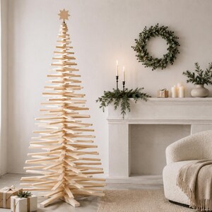 May include: A tall, conical Christmas tree constructed from stacked, horizontal light-colored wooden slats. The tree features a central vertical support and is topped with a small, light-colored wooden star ornament. The structure is freestanding.
