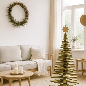 May include: A decorative Christmas tree constructed from stacked, horizontal green wooden slats arranged in a conical shape, topped with a light-colored wooden star. The structure stands on a floor, featuring a central vertical support pole.