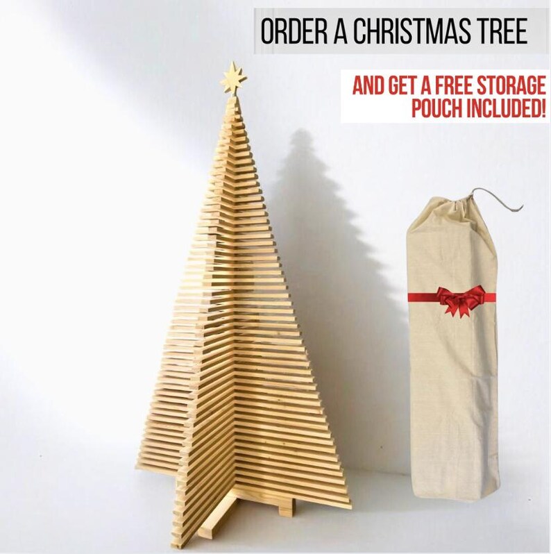 May include: A light-colored wooden Christmas tree constructed from horizontal slats with a star topper, accompanied by a beige fabric storage pouch featuring a red ribbon graphic. Text reads: ORDER A CHRISTMAS TREE AND GET A FREE STORAGE POUCH INCLUDED!