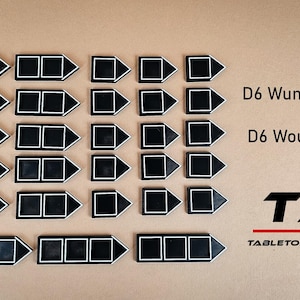 May include: Twenty-four black and white wound trackers with arrow shapes. The trackers are arranged in four rows of six. The text "D6 Wunden Tracker" and "D6 Wound Tracker" are visible in the image. The text "TAB Tabletop and Beyond" is also visible.